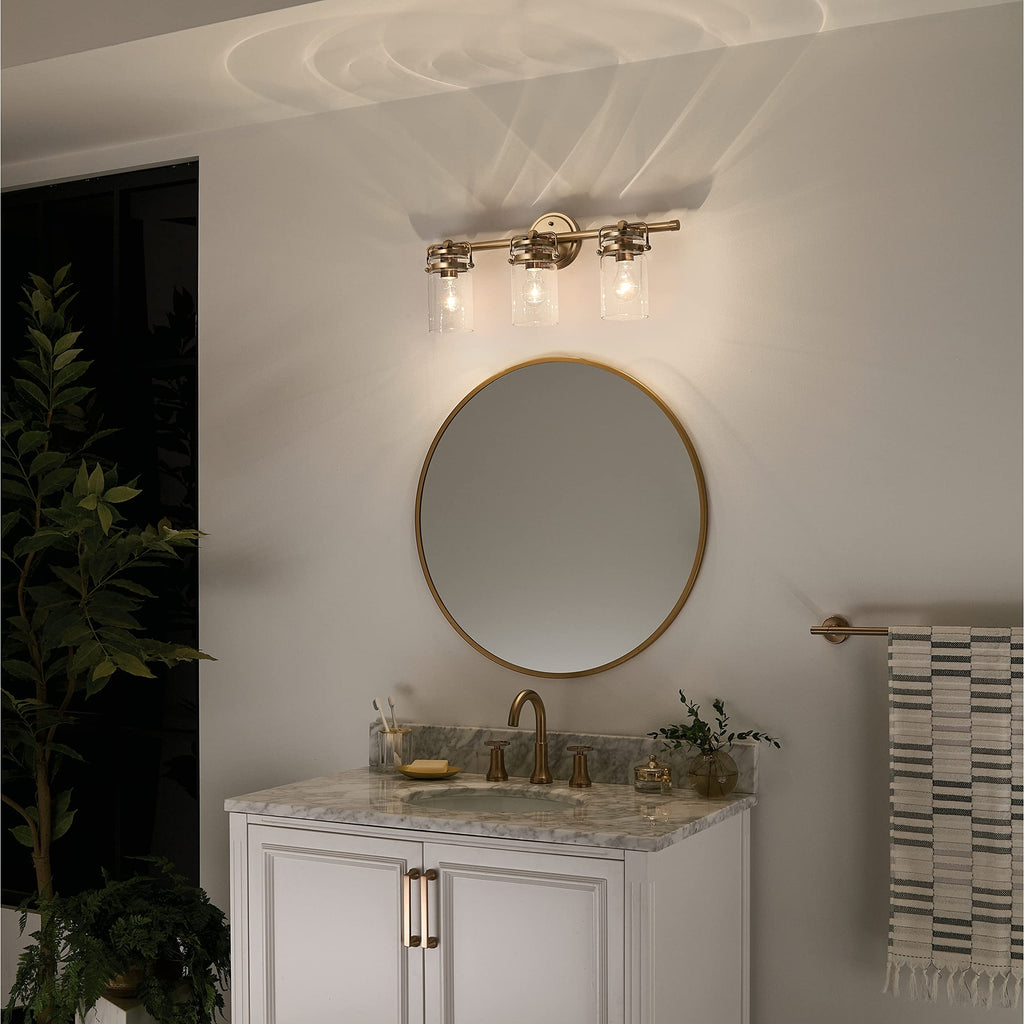 Kichler, Brinley 24" 3 Light Vanity Light with Clear Glass in Champagne Bronze,
