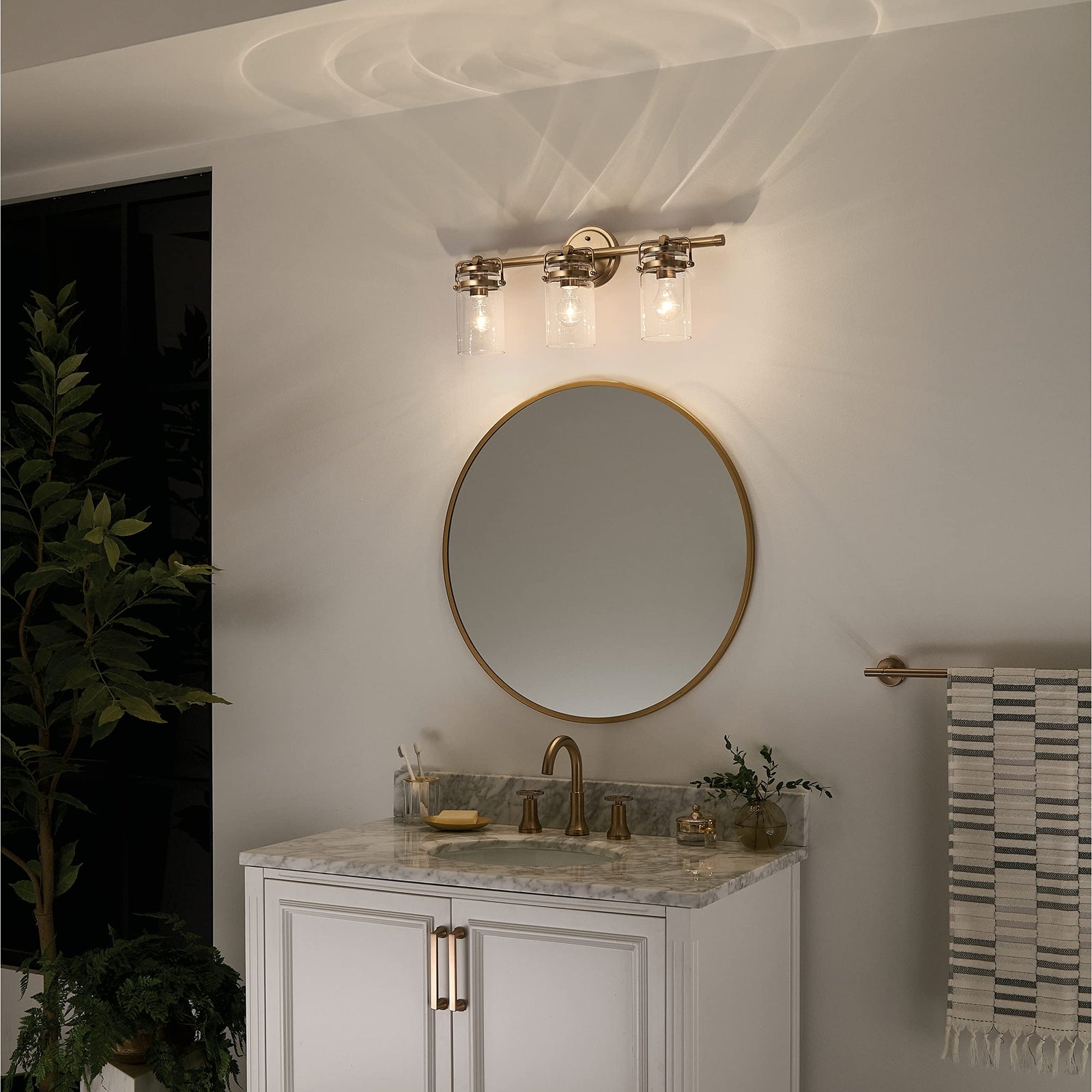 Kichler, Brinley 24" 3 Light Vanity Light with Clear Glass in Champagne Bronze,