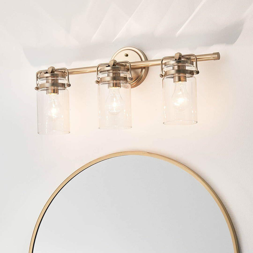 Kichler, Brinley 24" 3 Light Vanity Light with Clear Glass in Champagne Bronze,