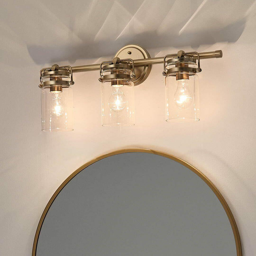 Kichler, Brinley 24" 3 Light Vanity Light with Clear Glass in Champagne Bronze,